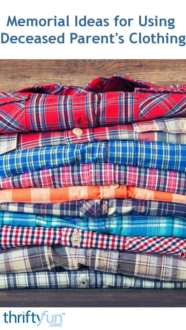 a pile of folded shirts sitting on top of a wooden table