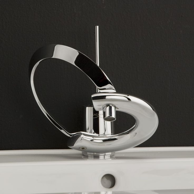 a chrome faucet mounted on the side of a wall