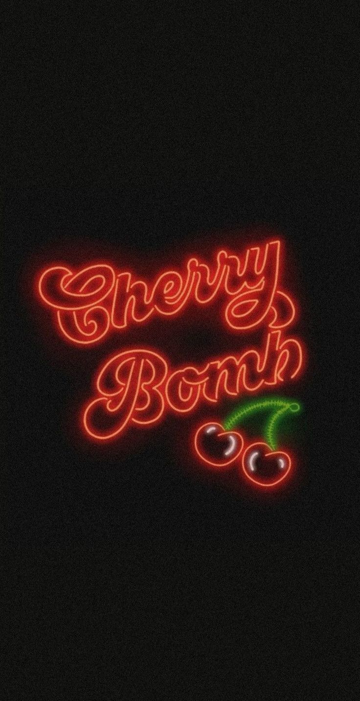 a neon sign that says cherry bomb on the side of a dark background with cherries