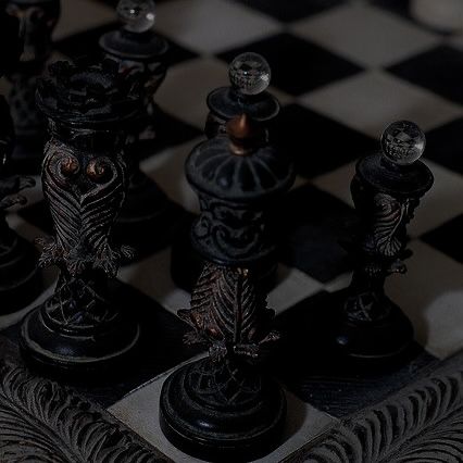 a black and white checkered board with chess pieces