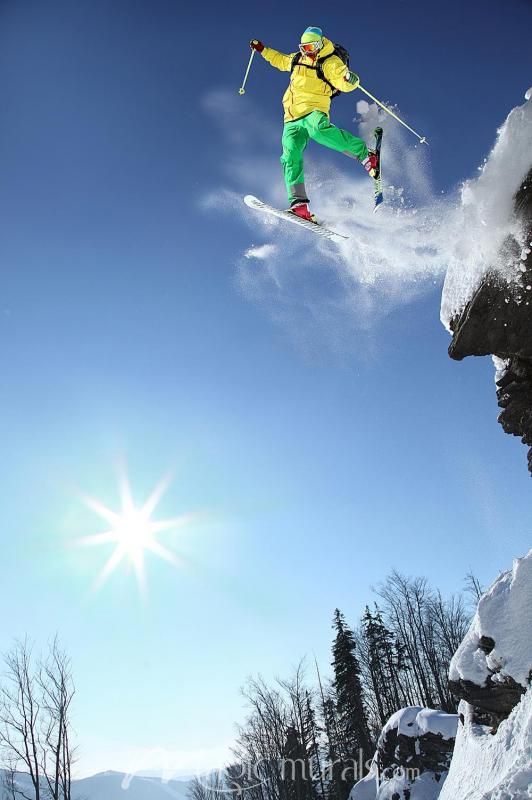 a man flying through the air while riding skis