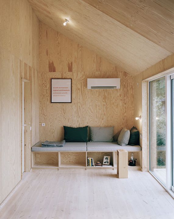 a living room with wooden walls and flooring