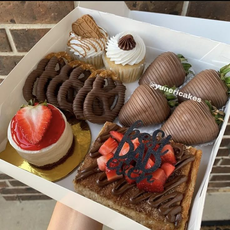 a box filled with lots of different types of desserts