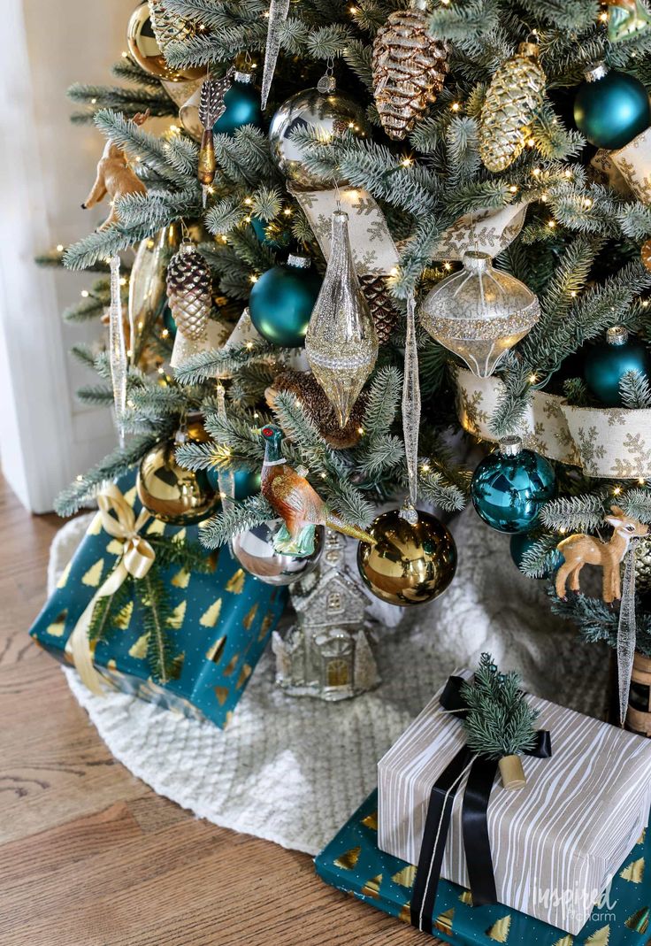 a christmas tree decorated with blue and gold ornaments