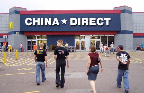 people walking in front of a store with the words china direct on it's side