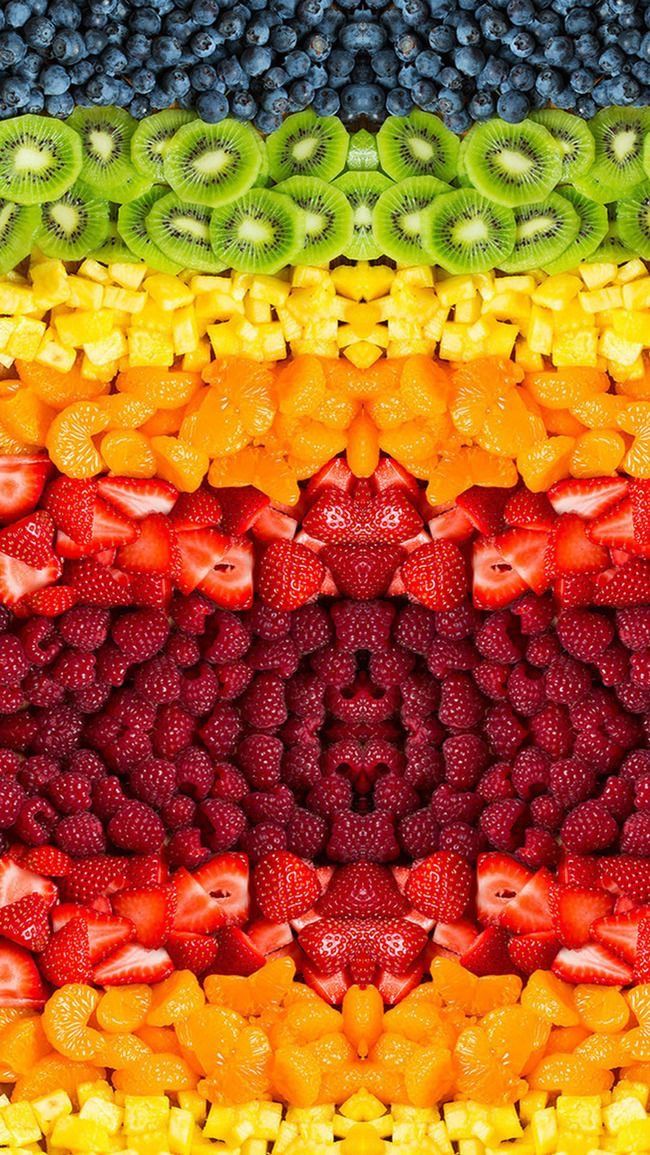 an array of fruits arranged in the shape of a rainbow