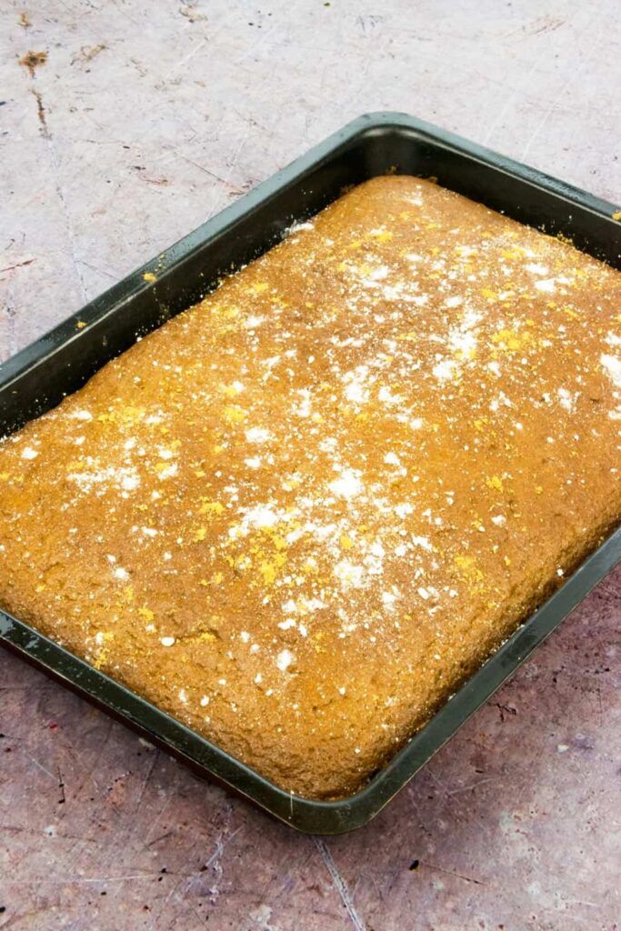 a pan filled with food sitting on top of a cement floor