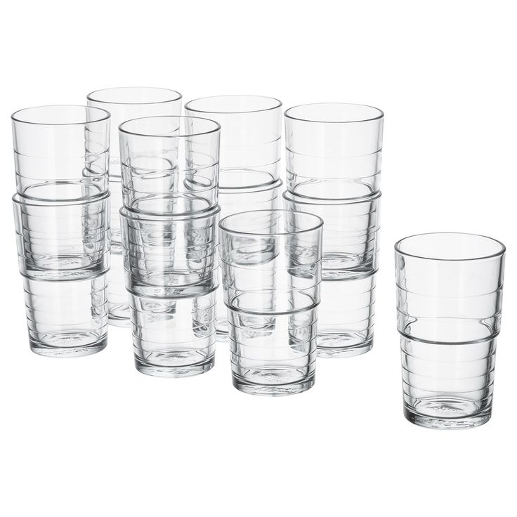 a set of twelve glasses sitting next to each other