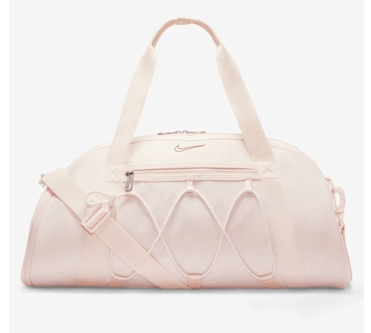 This spacious duffel bag from Nike is perfect for all your travel, casual, and work needs. The bag is made of 100% polyester exterior material and features a solid dusty pink pattern with silver, blush, light pink, baby pink, and rose character accents. It has a zip closure and comes with a detachable shoulder strap for added convenience. The bag is large in size, measuring 21 inches in width and 15 inches in height, and has a brown polyester lining. It also includes a pouch, coin purse, key holder, and detachable strap as accessories. The Nike One Club Women's Training Duffel Bag is a must-have for any sports enthusiast and is available for purchase now. Cheer Basketball, Nike Dance, Sport Bags Women, Volleyball Bag, Basketball Bag, School Bag Essentials, Tennis Bag, Training Bags, Dance Bag