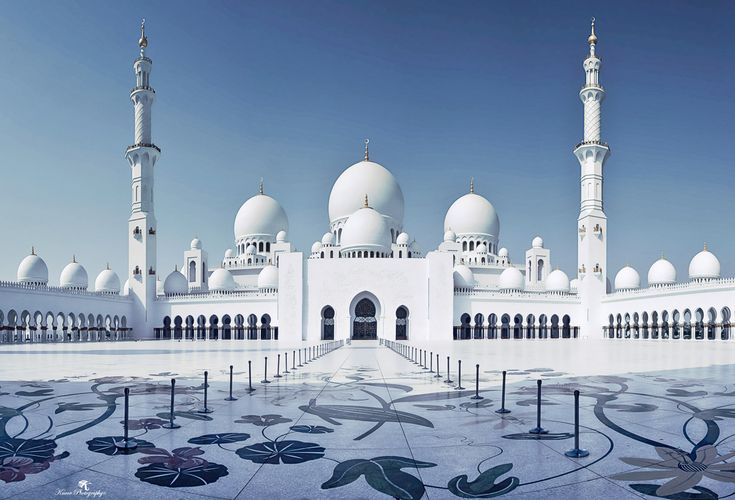 a large white building with many domes on it's sides and pillars in the middle