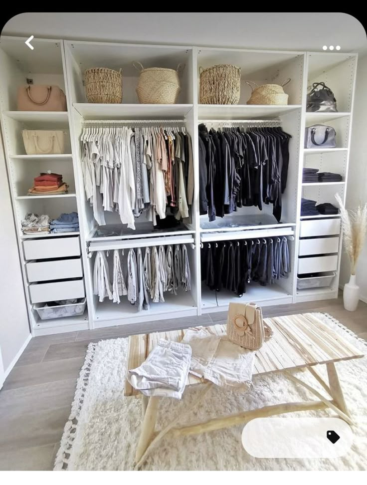 an organized closet with white shelving and lots of clothes