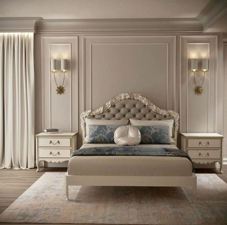 a bedroom with a bed, dressers and two lamps on either side of the bed