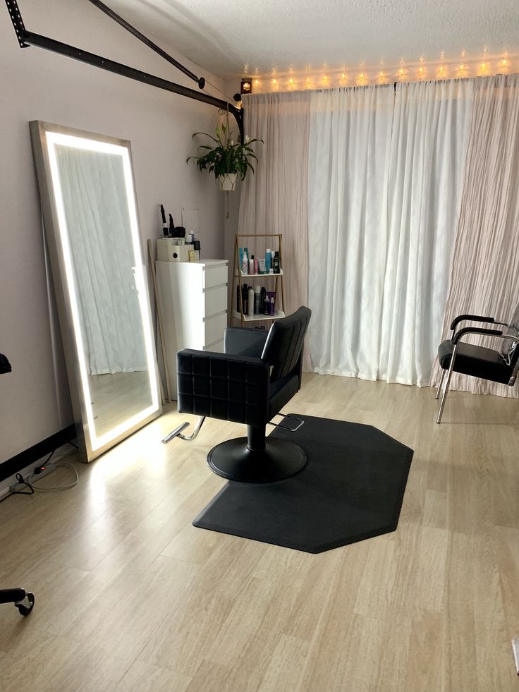 a chair and mirror in a room with lights on the wall behind it, along with other furniture