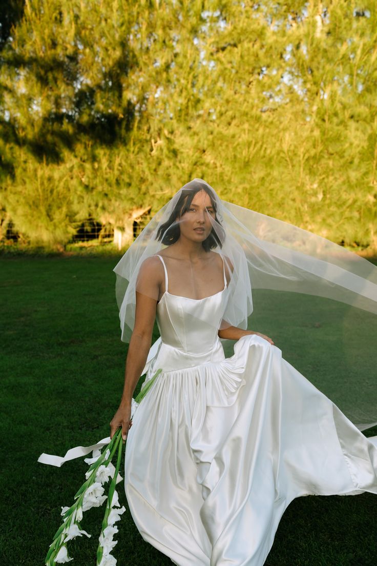 a woman in a wedding dress holding a bouquet