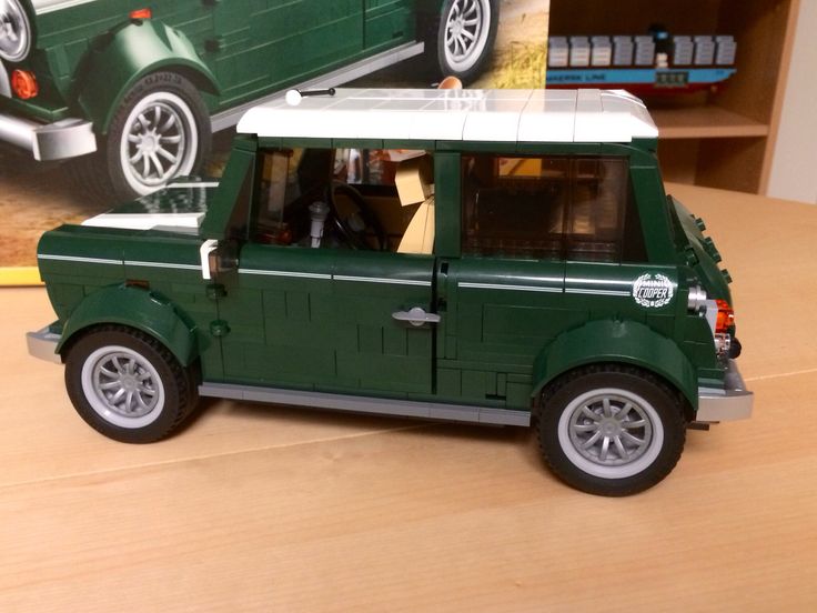 a green toy car sitting on top of a wooden table