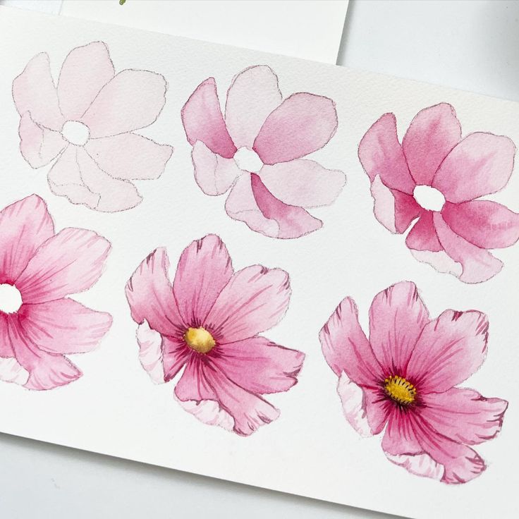 pink flowers painted on white paper with gold tips