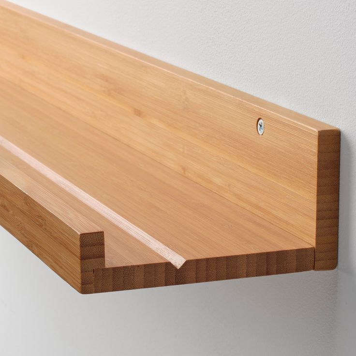 a close up of a wooden shelf on a wall with a hole in the middle