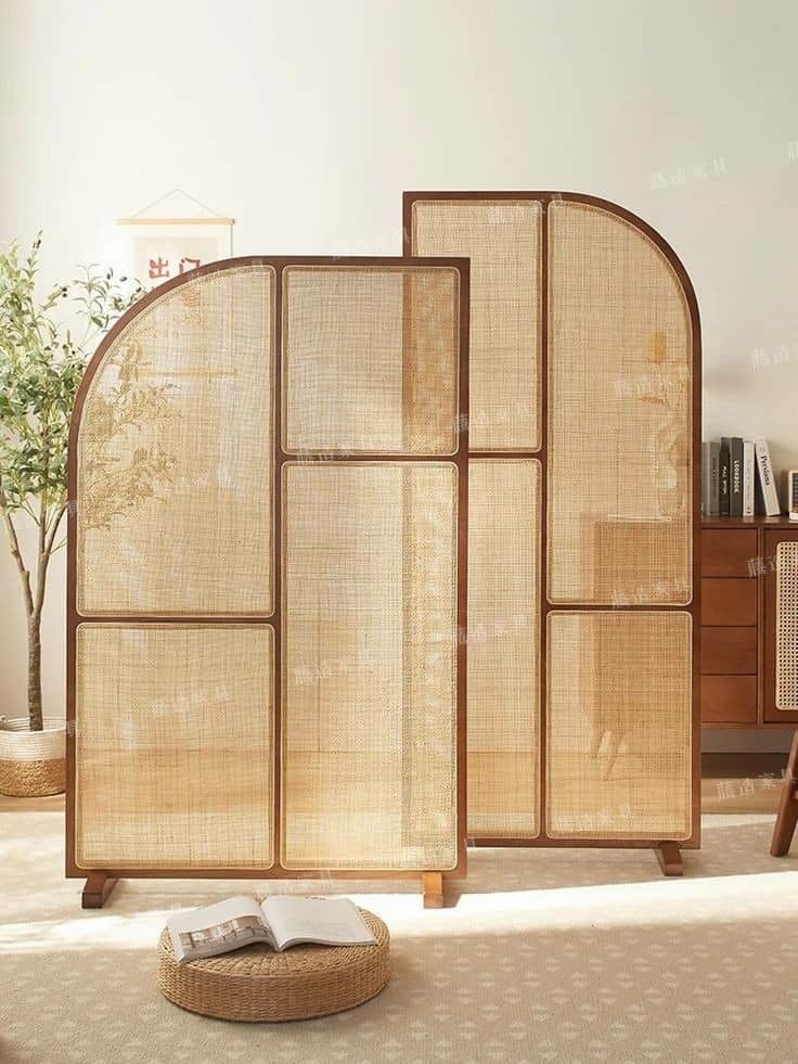 a room divider made out of bamboo with a book on the floor next to it