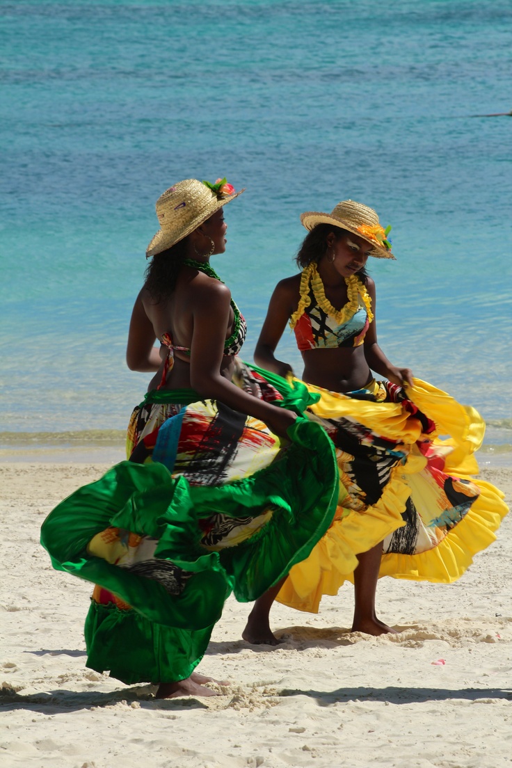 two women in colorful clothing on the beach