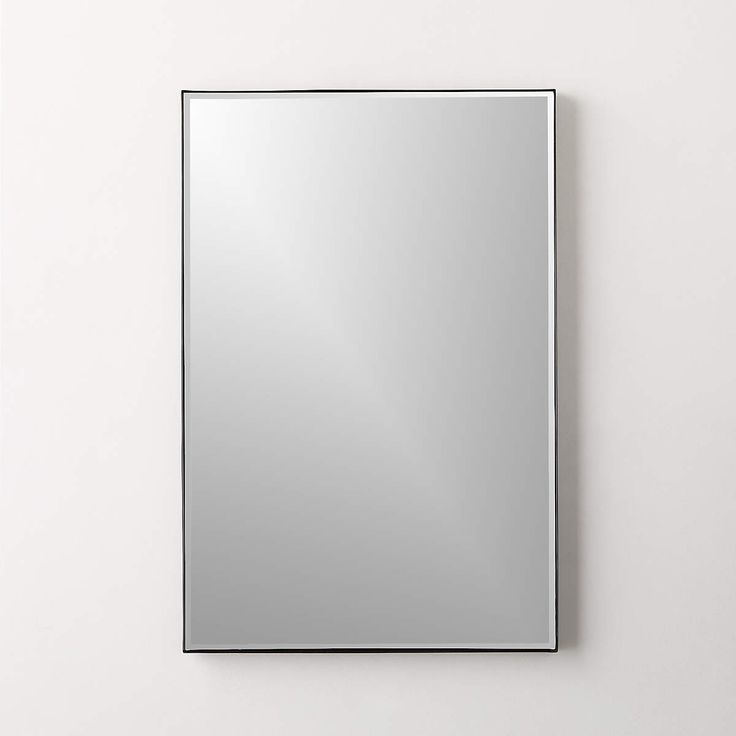 a square mirror mounted to the side of a wall