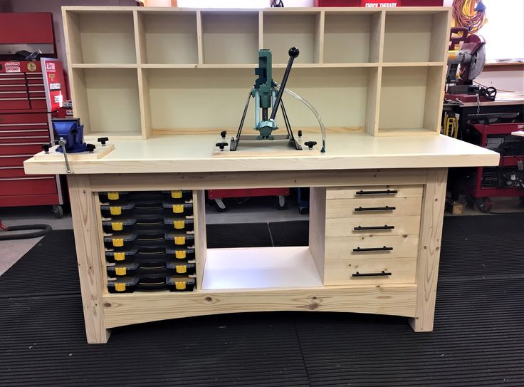 a workbench made out of plywood with tools on the top and drawers