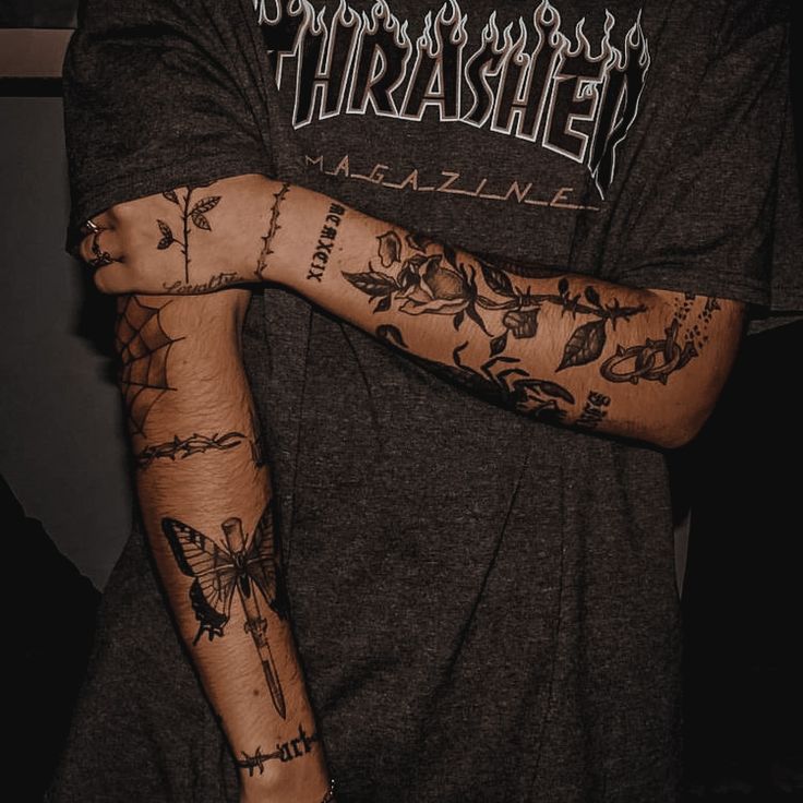 a man with many tattoos on his arm