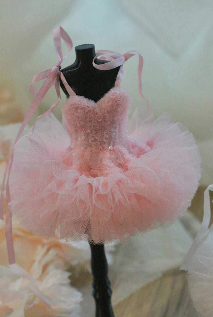 a pink tutule dress sitting on top of a mannequin