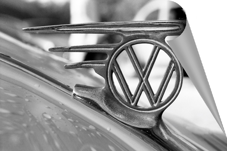 the vw emblem is on the hood of a vintage car in black and white