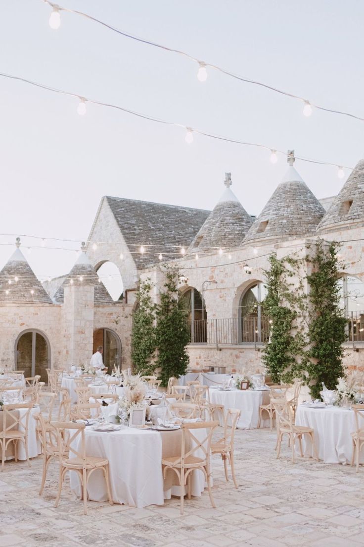 an outdoor wedding venue with tables and chairs set up for the guests to sit down