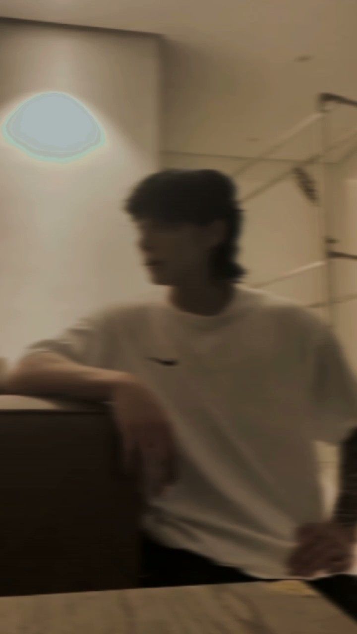 a blurry photo of a man in a white shirt