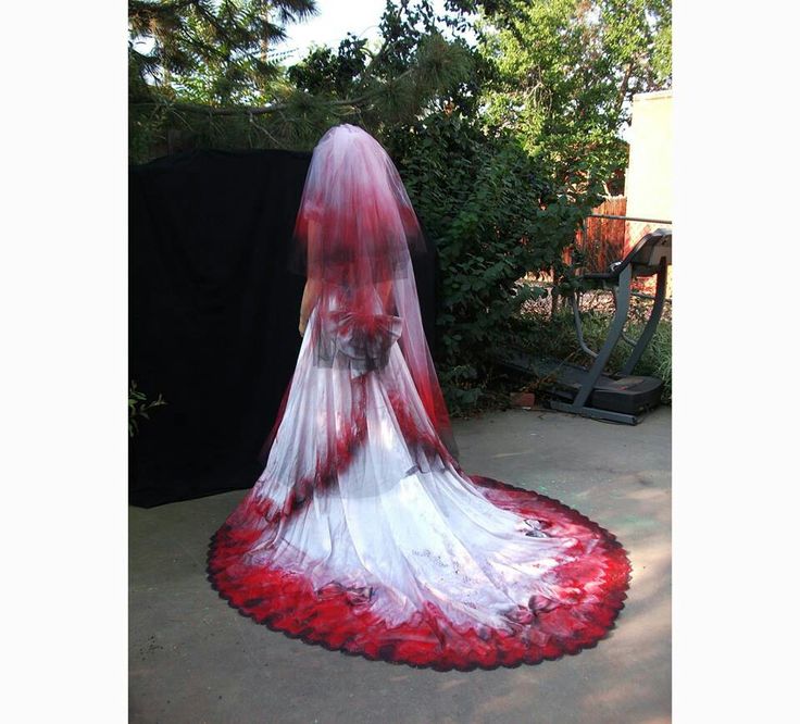 a red and white wedding dress on display outside