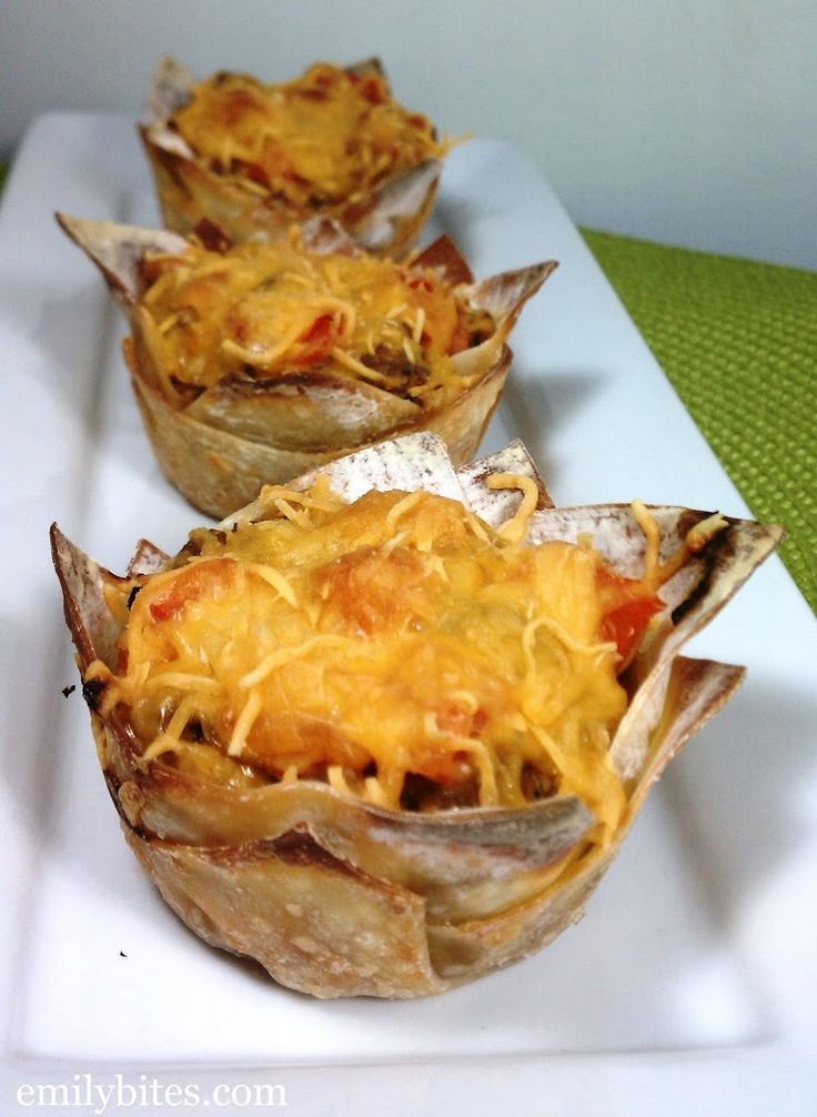 three cups filled with food sitting on top of a white plate