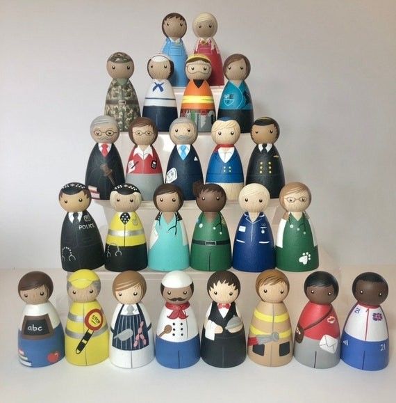 a group of wooden toy figurines sitting next to each other