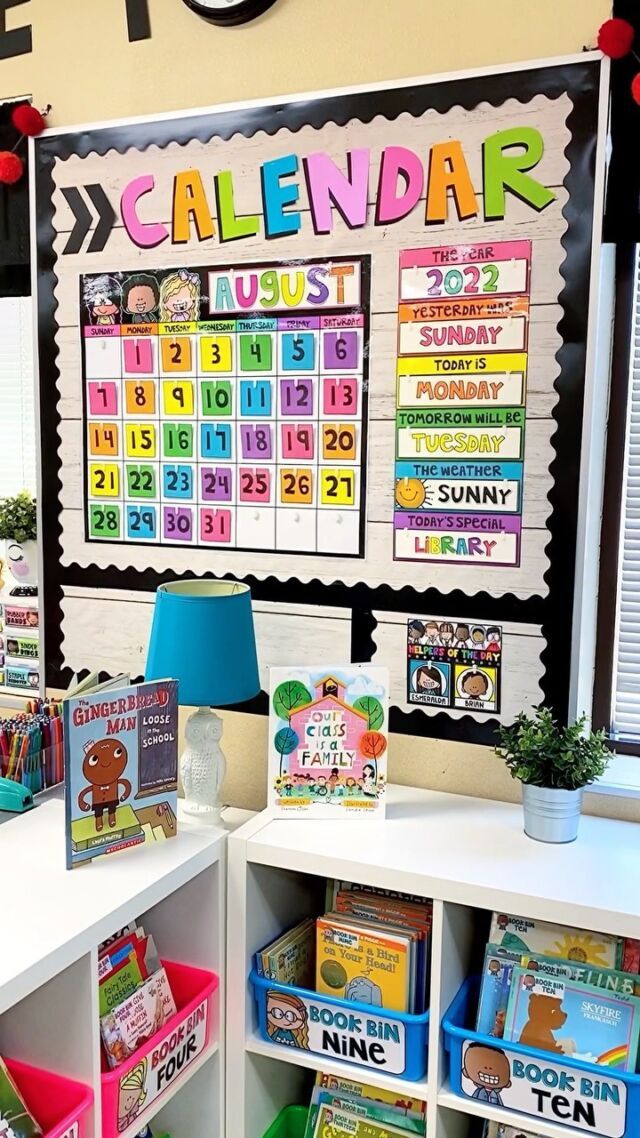 a classroom with calendars on the wall and toys in bins next to it