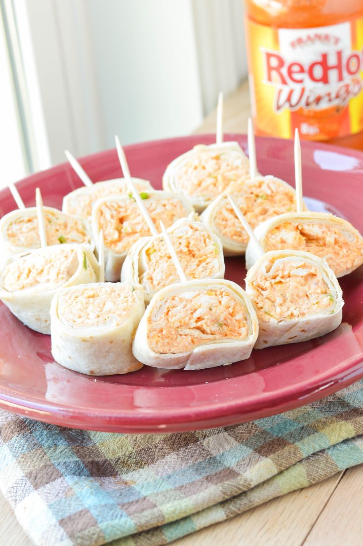 some food is on a red plate with toothpicks