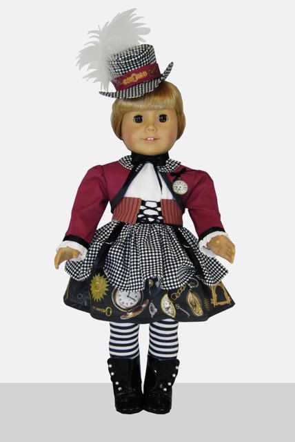 a doll is wearing a dress and hat with feathers on it's head, while standing in front of a white background