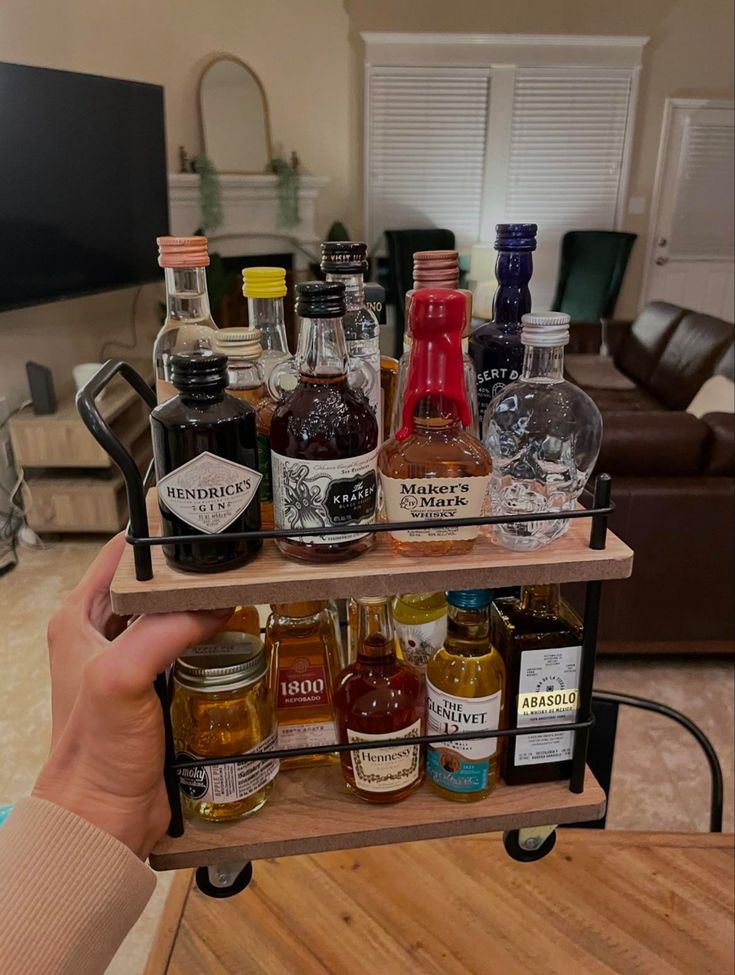 a person is holding a shelf with bottles on it