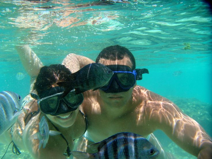 two people wearing goggles and snorkels in the water