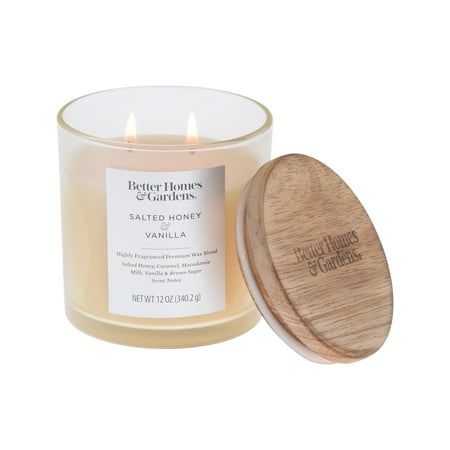 a glass candle with a wooden lid and label on the front that says better homes & gardens salted honey vanilla