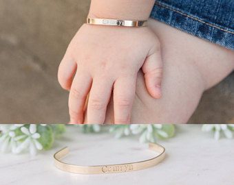 a baby's hand with a gold bracelet on it and another photo of a child's hand