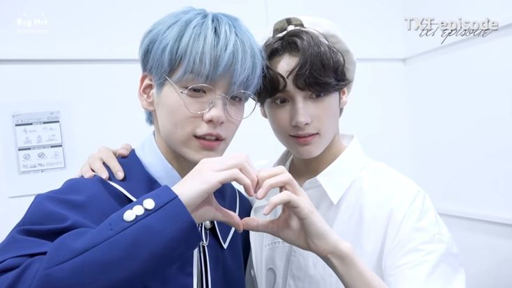 two young men standing next to each other with blue hair and glasses on their faces