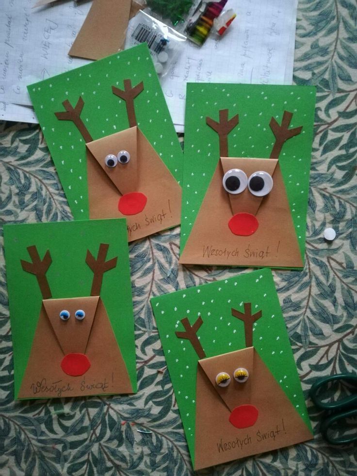 four christmas cards made to look like reindeers with googly eyes and nose on them