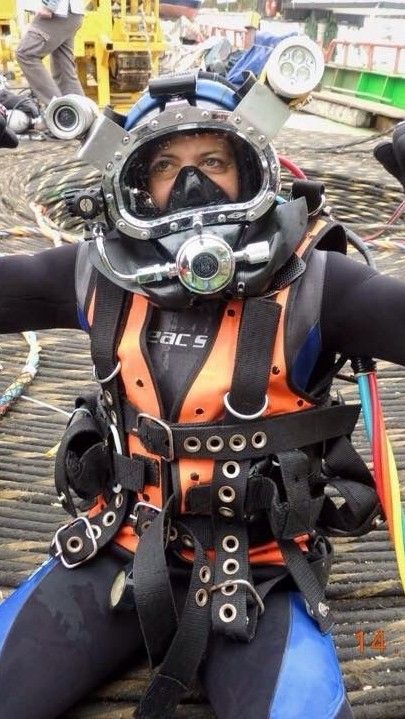 a man in scuba gear sitting on the ground