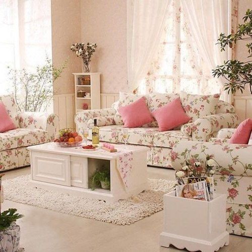 a living room filled with lots of furniture and flowers on the couches in front of a window