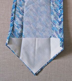 an origami tie with blue and white designs on it