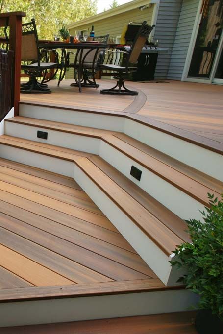 a wooden deck with steps leading up to it