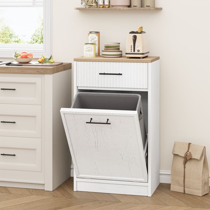 a kitchen with white cabinets and open bins