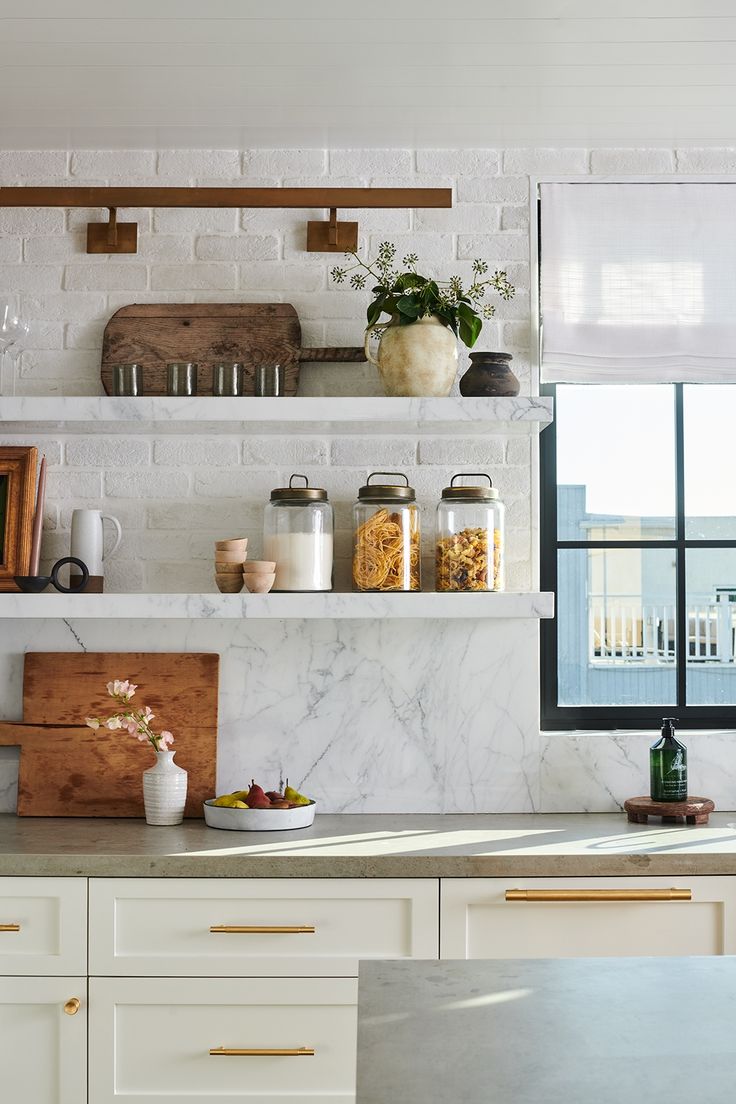 the kitchen counter is covered with jars and containers