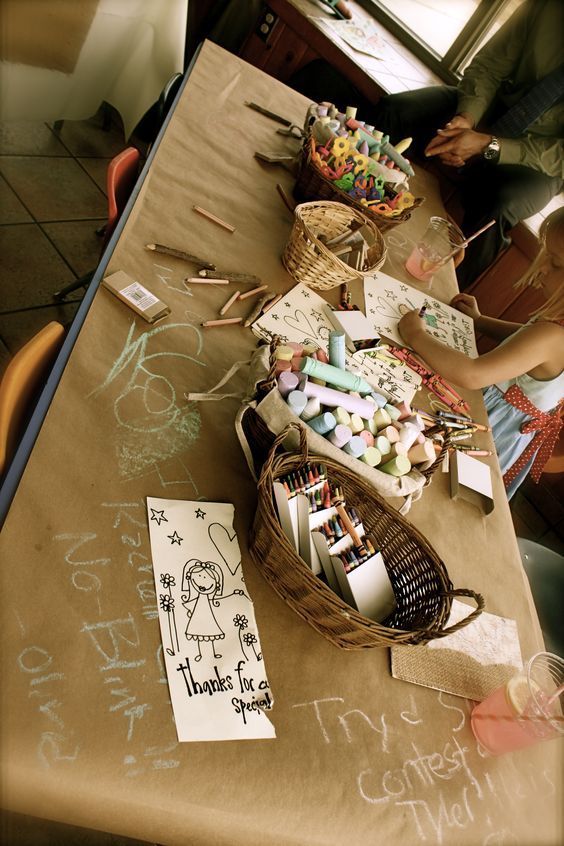 a table covered with lots of crafting supplies and crafts on it's sides