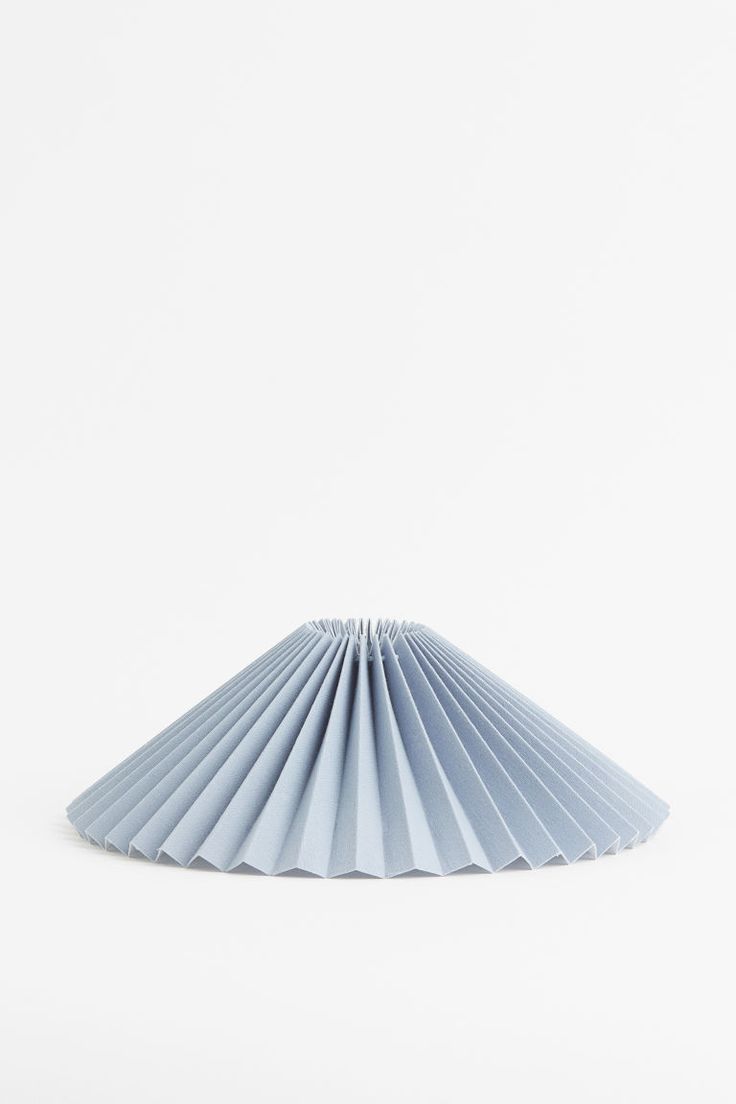 a blue paper fan sitting on top of a white table